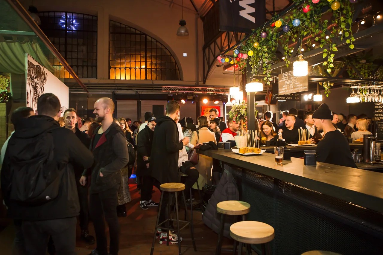 People eating and drinking inside Halės Market in Vilnius