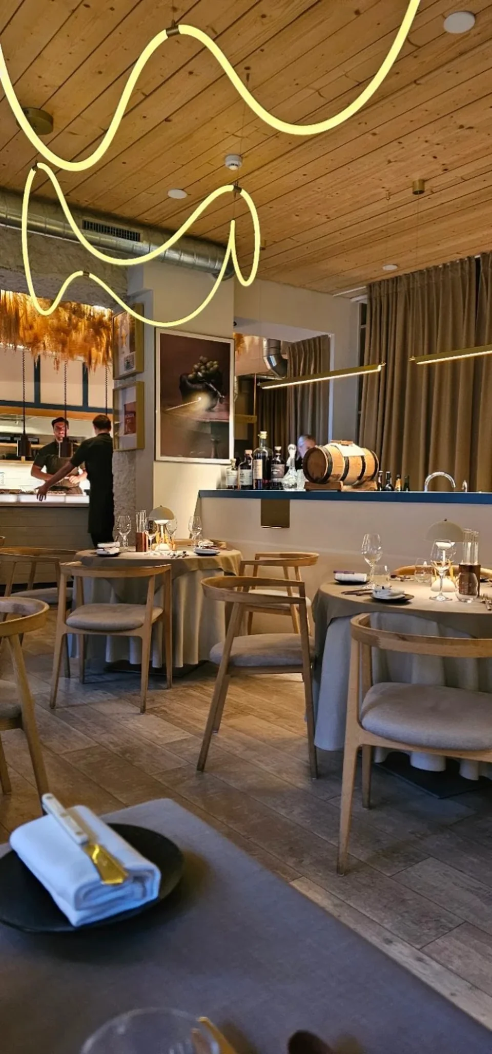 Amandus dining room with open kitchen and sculptural lighting.