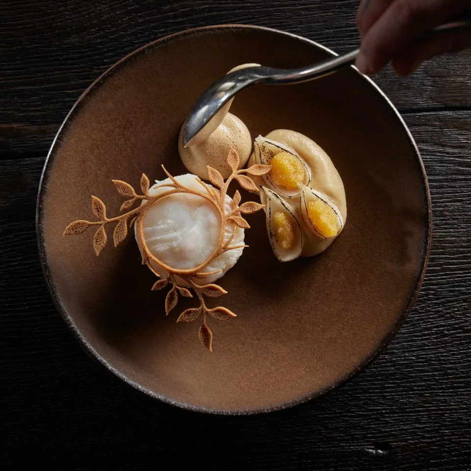 A carefully plated Fabrikėlis course on a dark table.