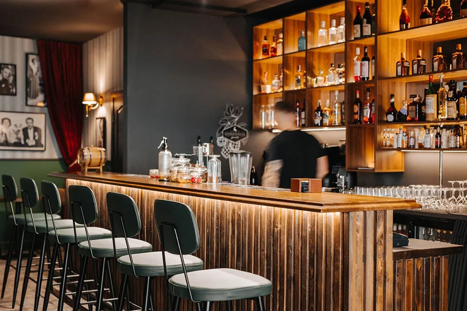 The illuminated bar counter and stools at Nick & Nora.