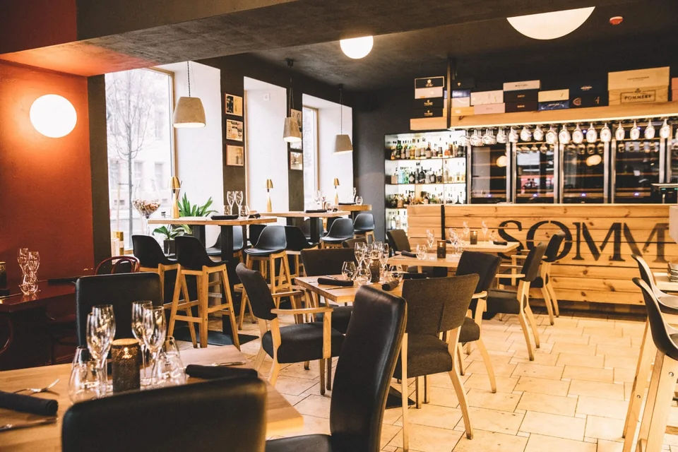 SOMM dining room, set tables and wine display.