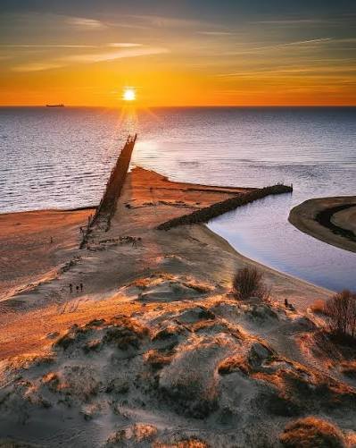 Sunset over the Šventoji River mouth and Baltic Sea